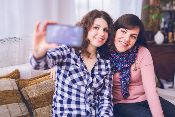istock Two woman enjoying indoor and make selfie. 1056297200