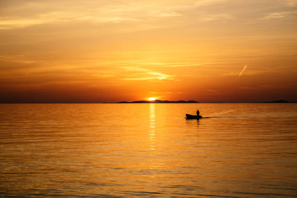 istock Fisherman coming home on boat during sunset 1056298884