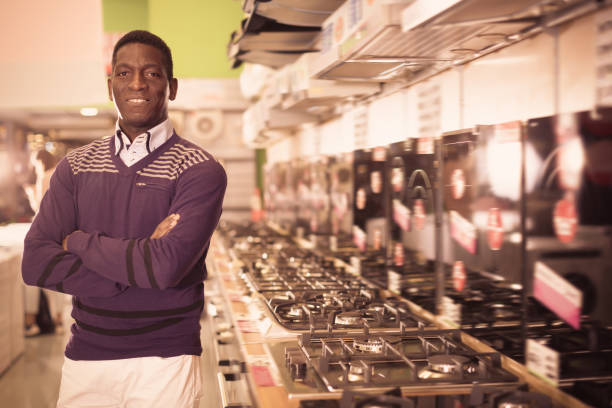 istock Smiling man selecting new cooking top in store 1056299272