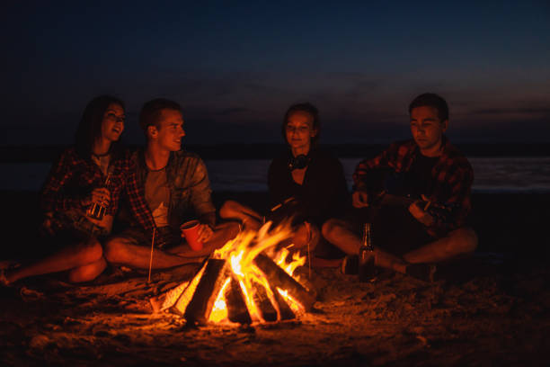 istock young friends have picnic with bonfire on the beach 1056299640