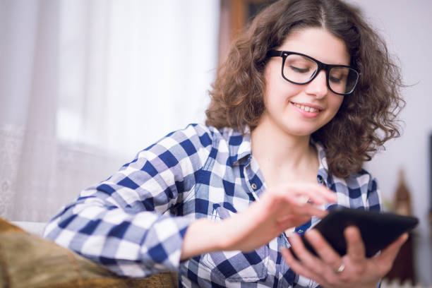 istock Happy young woman using tablet indoor. 1056299642