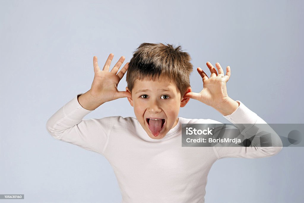 Making a Face cute boy sticking his tongue out Brat Stock Photo