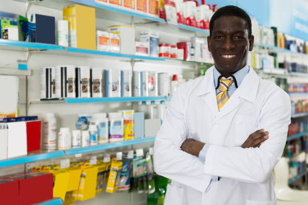 istock man druggist standing on background with shelves 1056301808