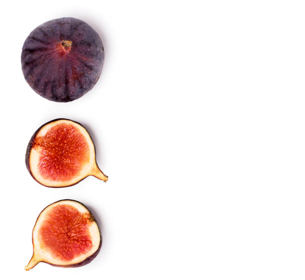 istock Ripe figs and two halves on a white. The view from the top. 1056306454