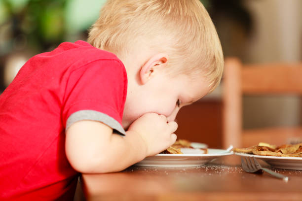 istock Little boy eating pancakes for breaktfast 1056306534