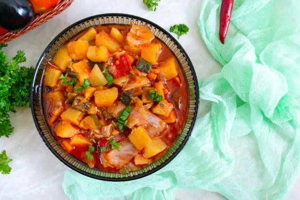 Photo of Delicious vegetable stew in a glass bowl. A popular dish of many countries of the world. Vegetarian menu. The top view