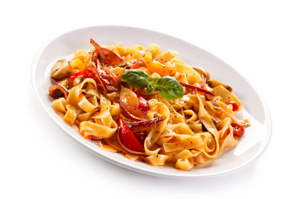 istock Pasta, pesto sauce and vegetables on white background 1056314000