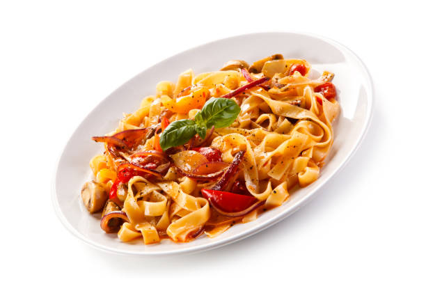 istock Pasta, pesto sauce and vegetables on white background 1056314032