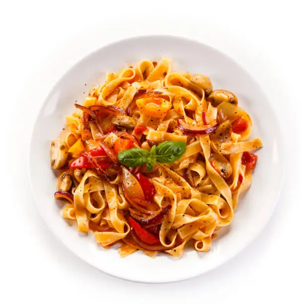 Pasta, pesto sauce and vegetables on white background