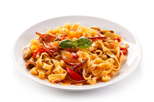 istock Pasta, pesto sauce and vegetables on white background 1056314438