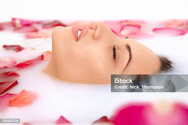 Attractive Girl Takes A Bath With Milk And Rose Petals Stock Photo - Download Image Now