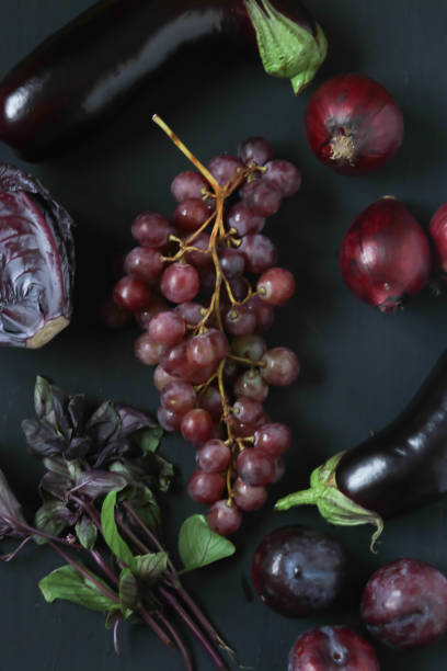istock Red and purple foods on a black background 1056320120
