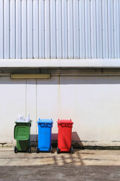 istock Three color plastic recycle bin in factory 1056322842
