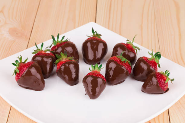 istock Strawberries in chocolate on the white plate. 1056324196