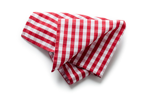 Top view of a folded picnic red cloth isolated on white background. Useful copy space available for text and/or logo. Predominant colors are red and white. High key DSRL studio photo taken with Canon EOS 5D Mk II and Canon EF 100mm f/2.8L Macro IS USM.