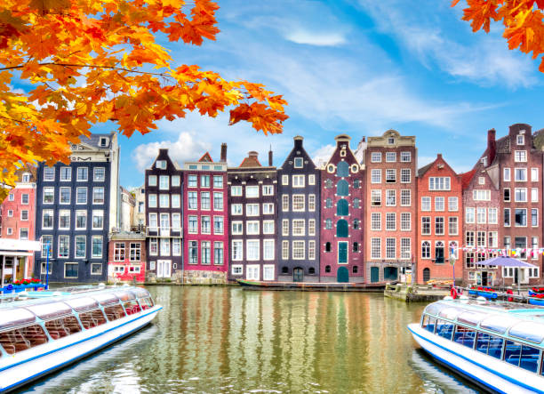 istock Amsterdam architecture at Damrak canal in autumn, Netherlands 1056331604