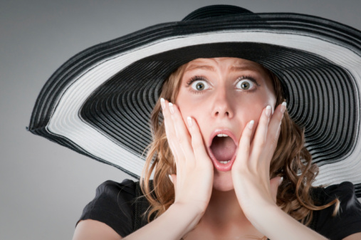 woman in a summer hat shocked