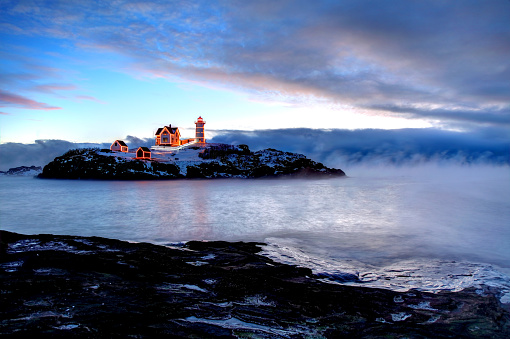 Frigid arctic sea smoke at Cape Neddick Lighthouse. The Town of York Maine is the permanent guardian for the Nubble Lighthouse (Cape Neddick Light Station). The United States Coast Guard continues to maintain the aids to navigation (the Light and the Horn).