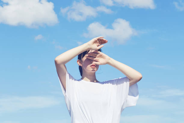 istock the blue sky and the annonymous woman 1056344310