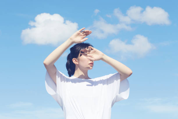 istock the blue sky and the annonymous woman 1056344340