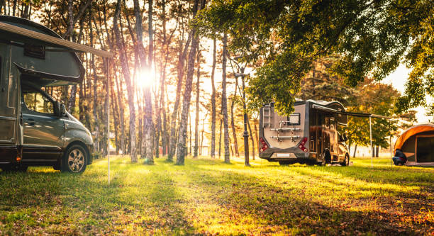 istock camping car in forest on sunset. 1056344600