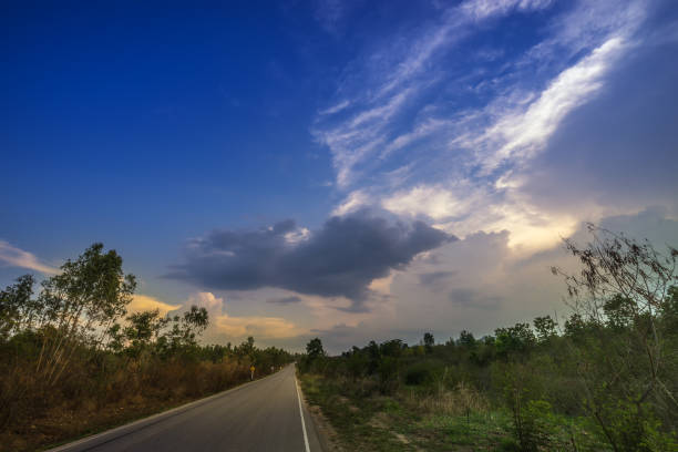 istock highway road on blue sky and tree - can use to display or montage on product 1056352072
