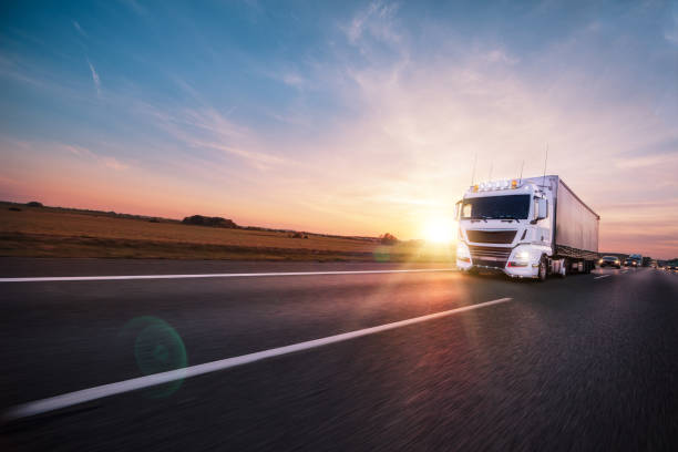 istock Truck with container on road, cargo transportation concept. 1056356302