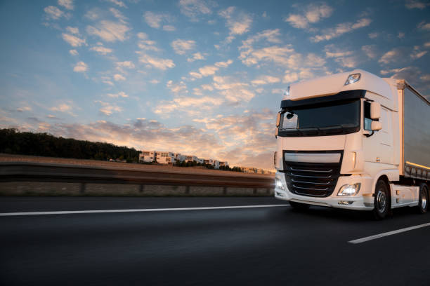 istock Truck with container on road, cargo transportation concept. 1056356384