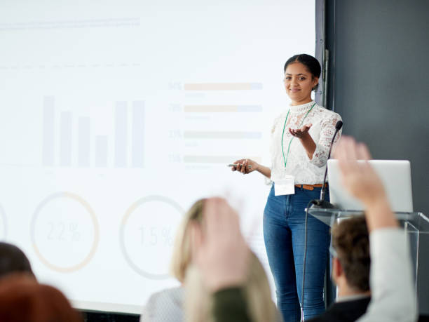 I'll take questions from the audience now Shot of a young businesswoman delivering a presentation at a conference keynote speech stock pictures, royalty-free photos & images