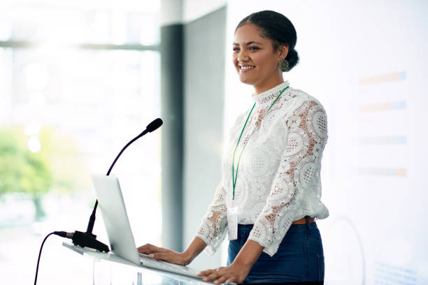 I'm looking forward to sharing the information with you all Shot of a young businesswoman delivering a presentation at a conference presentation speech stock pictures, royalty-free photos & images