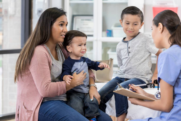 istock Mother visits the pediatrician with her sons 1056360008