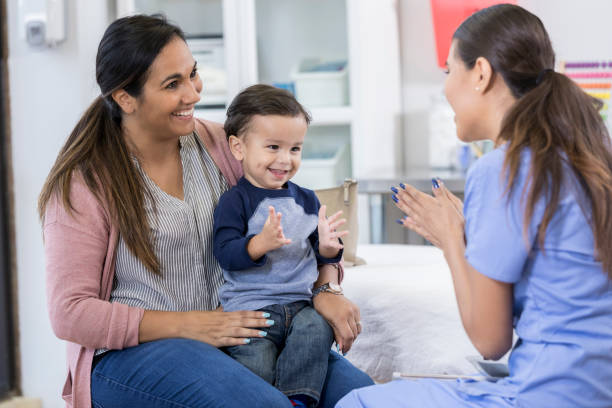 istock Toddler enjoys playing patacake with pediatrician 1056360016