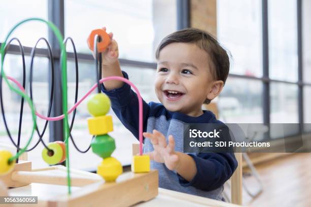 Toddler Boy Enjoys Playing With Toys In Waiting Room Stock Photo - Download Image Now