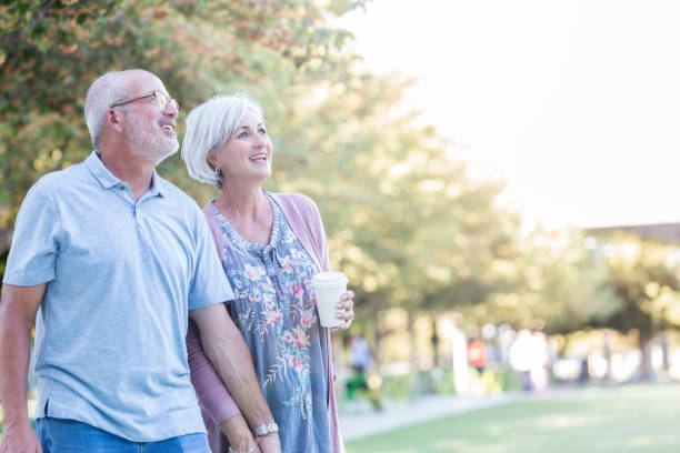 istock Senior couple walk together in the park 1056360120
