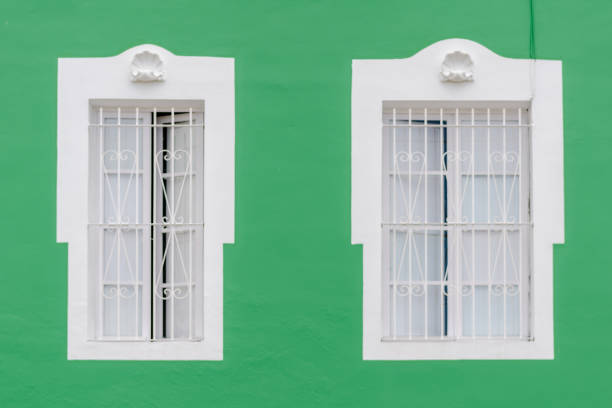 istock two windows on a green facade of an old house 1056361314