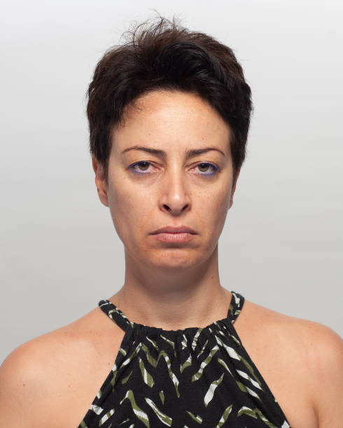 istock sad woman in front of gray background 1056363756