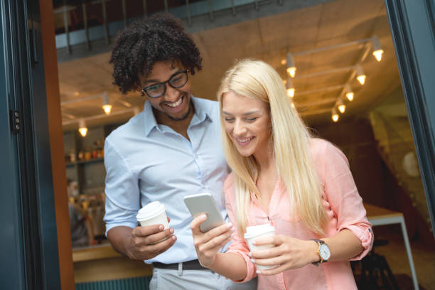 istock Couple social networking while drinking a cup of coffee to go 1056372968