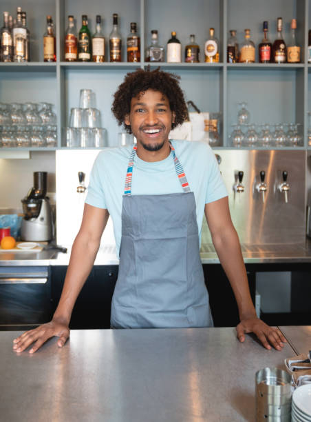 istock Cheerful man working at a restaurant behind the counter 1056373136