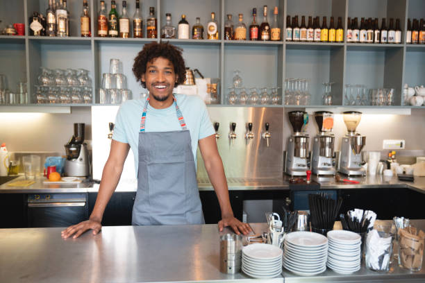 istock Happy man working at a restaurant behind the counter 1056373148
