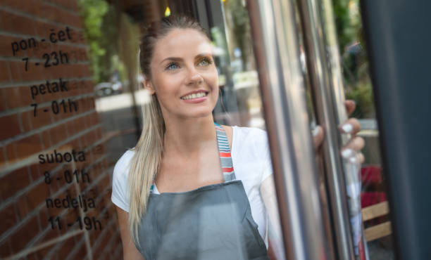 istock Happy manager opening the door at a cafe 1056373244