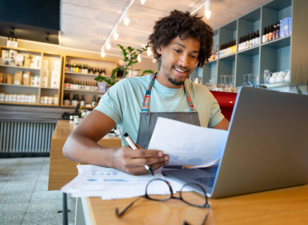 istock Happy business manager doing the books at a restaurant 1056373292