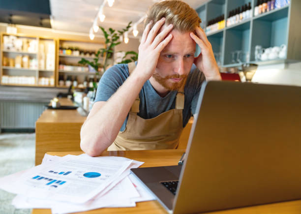 Business manager looking worried doing the books