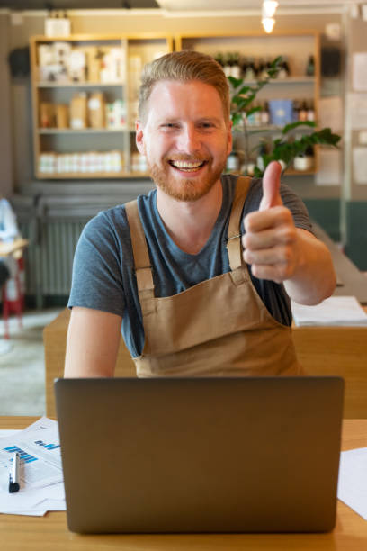 istock Happy manager doing the books at a restaurant 1056373408