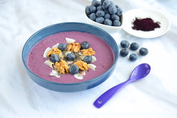 istock Acai smoothie bowl with blueberry, coconut chips, walnut and chia seeds 1056377596