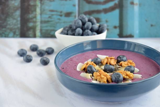 istock Acai smoothie bowl with blueberry, coconut chips, walnut and chia seeds 1056377642