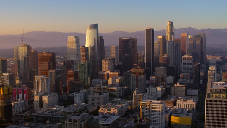 AERIAL Skyscrapers in Downtown Los Angeles at sunset