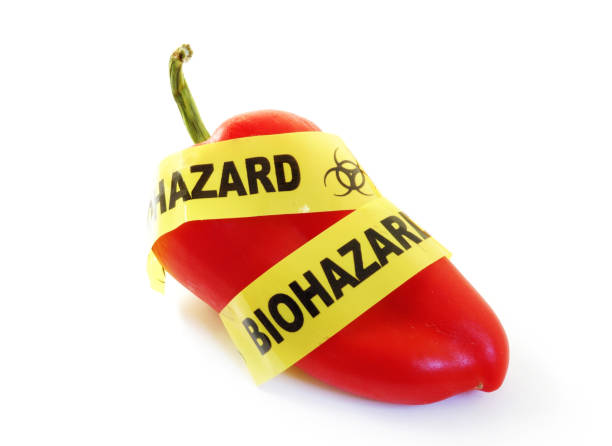 food safety warning Red pepper with bio-hazard tape.food safety concept food recall stock pictures, royalty-free photos & images