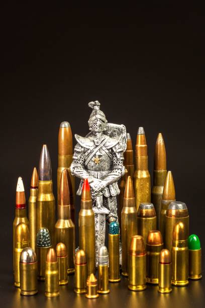 istock Medieval knight and modern ammunition. Different types of ammunition on a black background. Sale of weapons and ammunition. The right to hold a gun. 1056385462