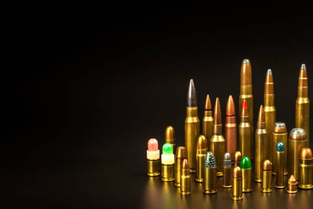 different types of ammunition on a black background. sale of weapons and ammunition. the right to hold a gun. - full metal jacket imagens e fotografias de stock