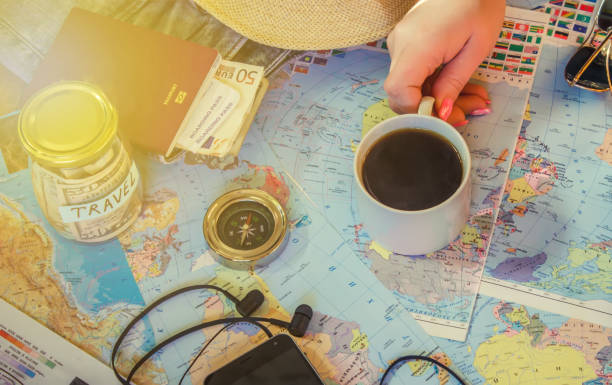 istock Background the journey, the reflection in the Cup of coffee. Map. Selective focus. 1056390698
